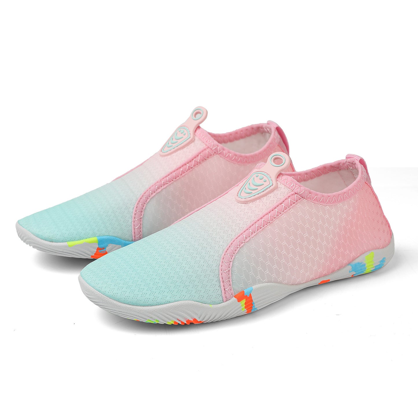 Pair of pink and blue water shoes on a white background