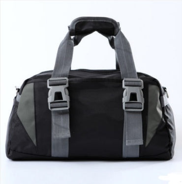 Black duffel bag with gray straps on a white background