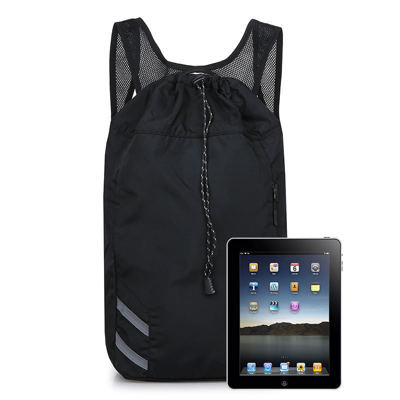 Black drawstring bag next to an iPad on a white background
