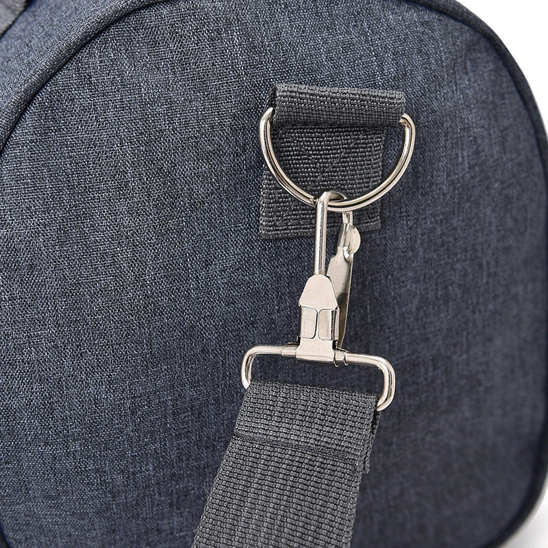 Close-up of a dark blue bag with a metal clasp and strap.