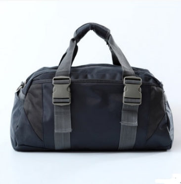 Black duffel bag with gray straps on a white background