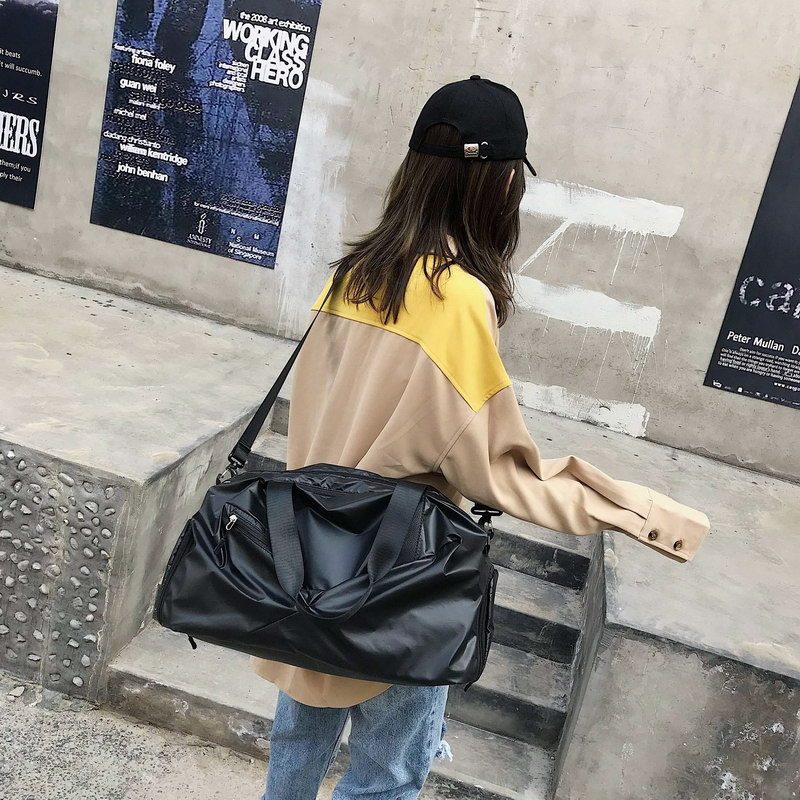 Person carrying a black bag on a concrete staircase with posters in the background