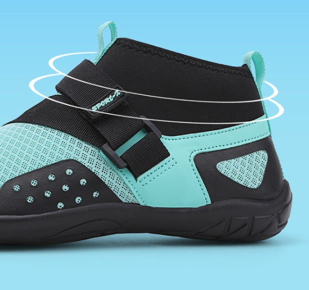 Teal and black shoe with white laces on a blue background