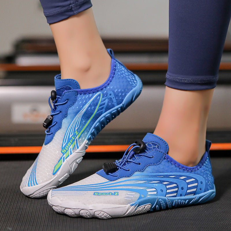 Blue and white athletic shoes worn by a person on a blurred indoor background