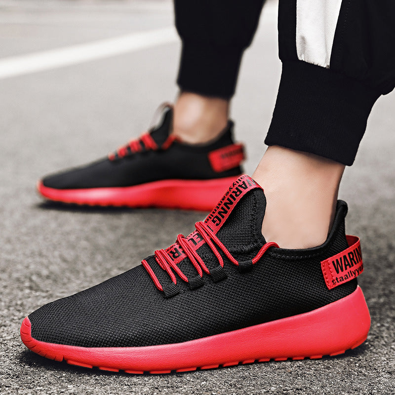 Black and red sneakers with visible branding on a pavement background