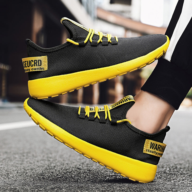 Black and yellow sneakers with visible branding on a blurred street background