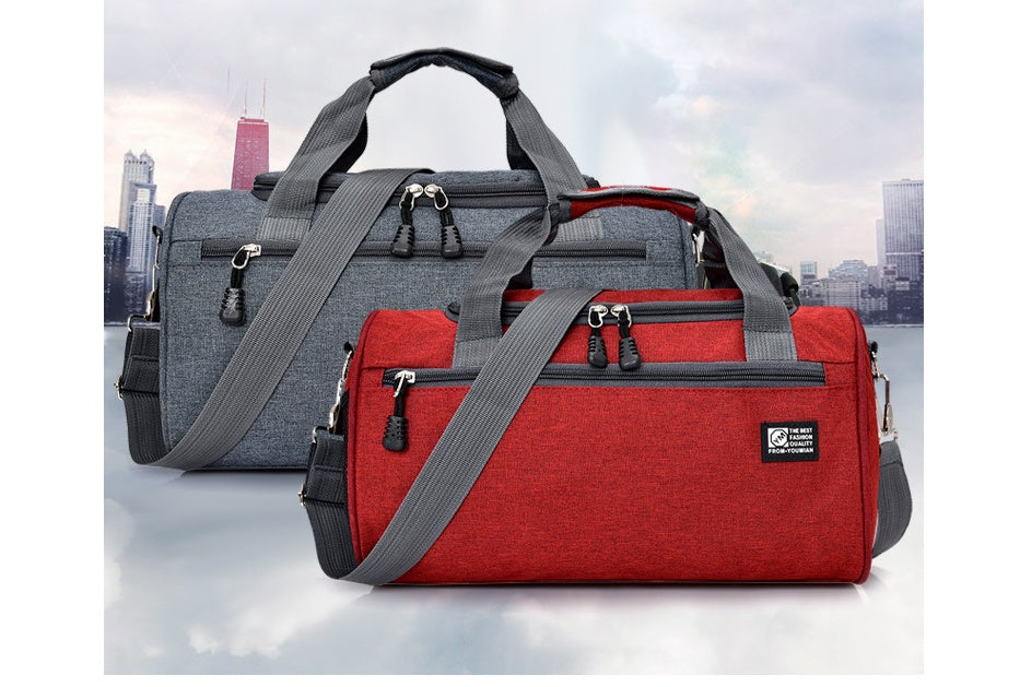 Red and gray duffel bags with a cityscape background