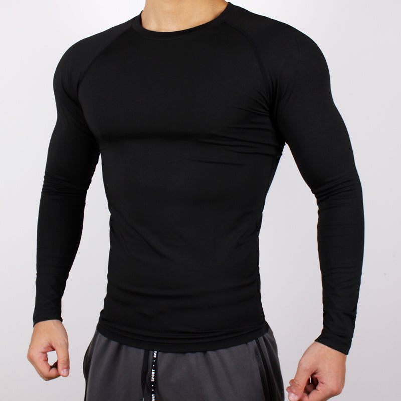 Black long-sleeve athletic shirt worn by a person on a light gray background