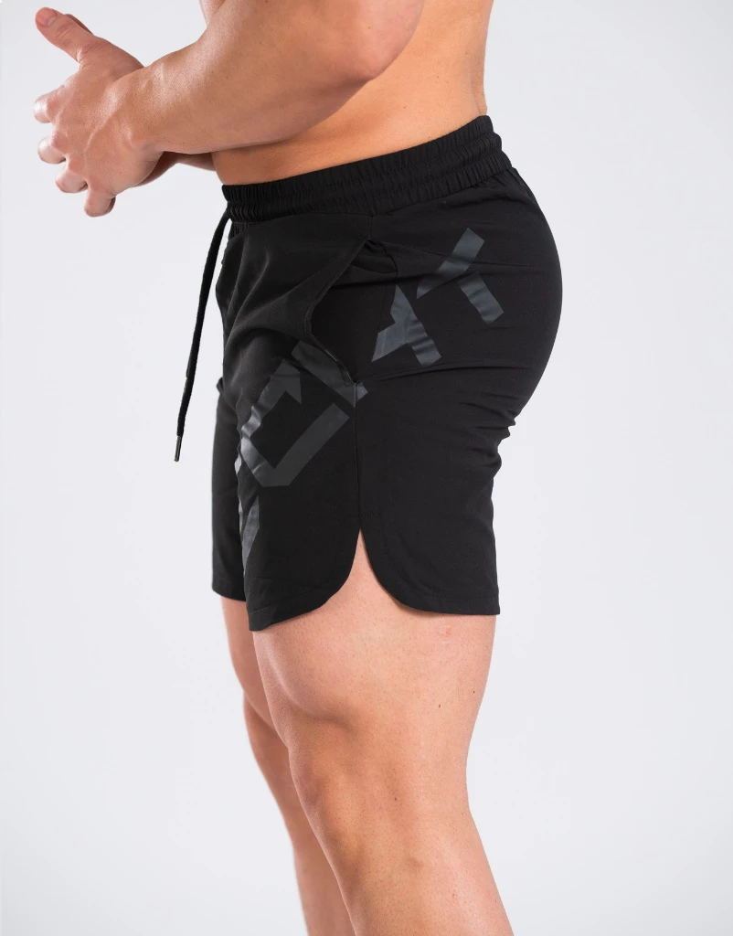 Black athletic shorts with a brand logo on a white background
