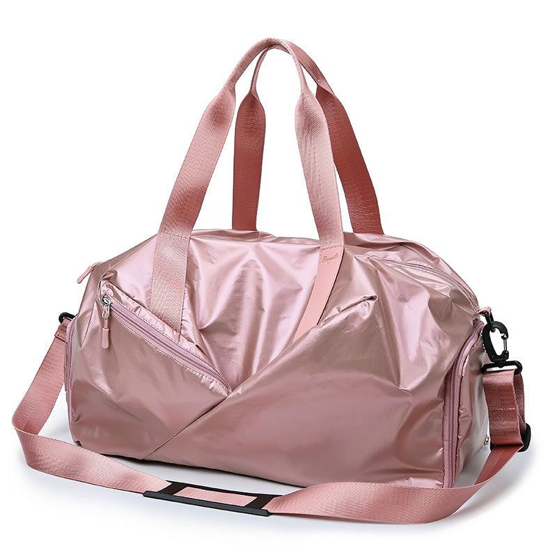 Pink duffel bag with a shoulder strap on a white background