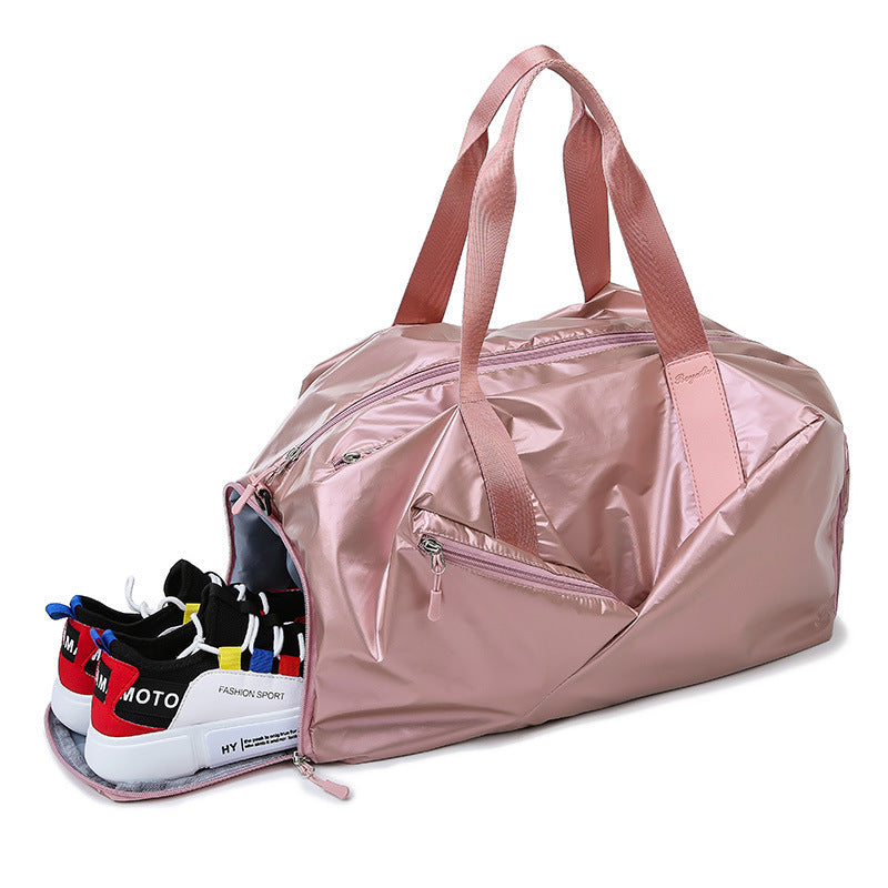 Pink duffel bag with open side showing colorful sneakers inside on a white background