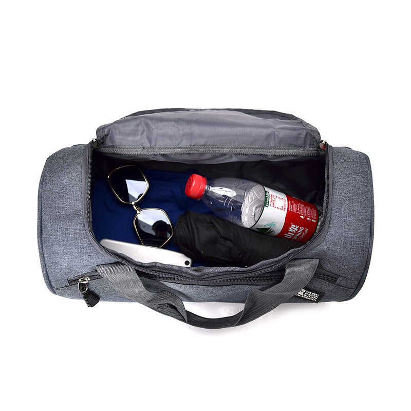 Gray duffel bag with sunglasses, phone, and water bottle on a white background