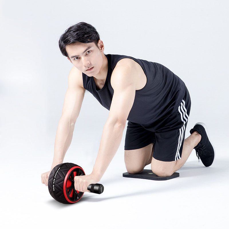 Man exercising with an ab roller on a white background