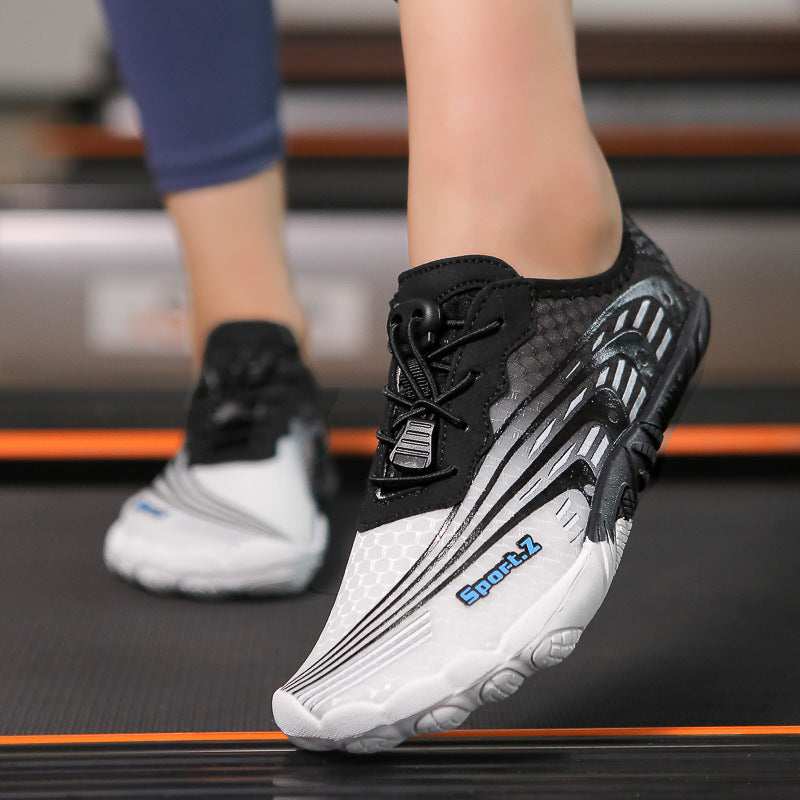 Black and white athletic shoe with visible branding on a treadmill background