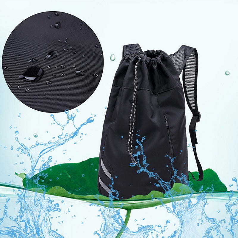Black drawstring bag with water droplets and water splashes on a light blue background