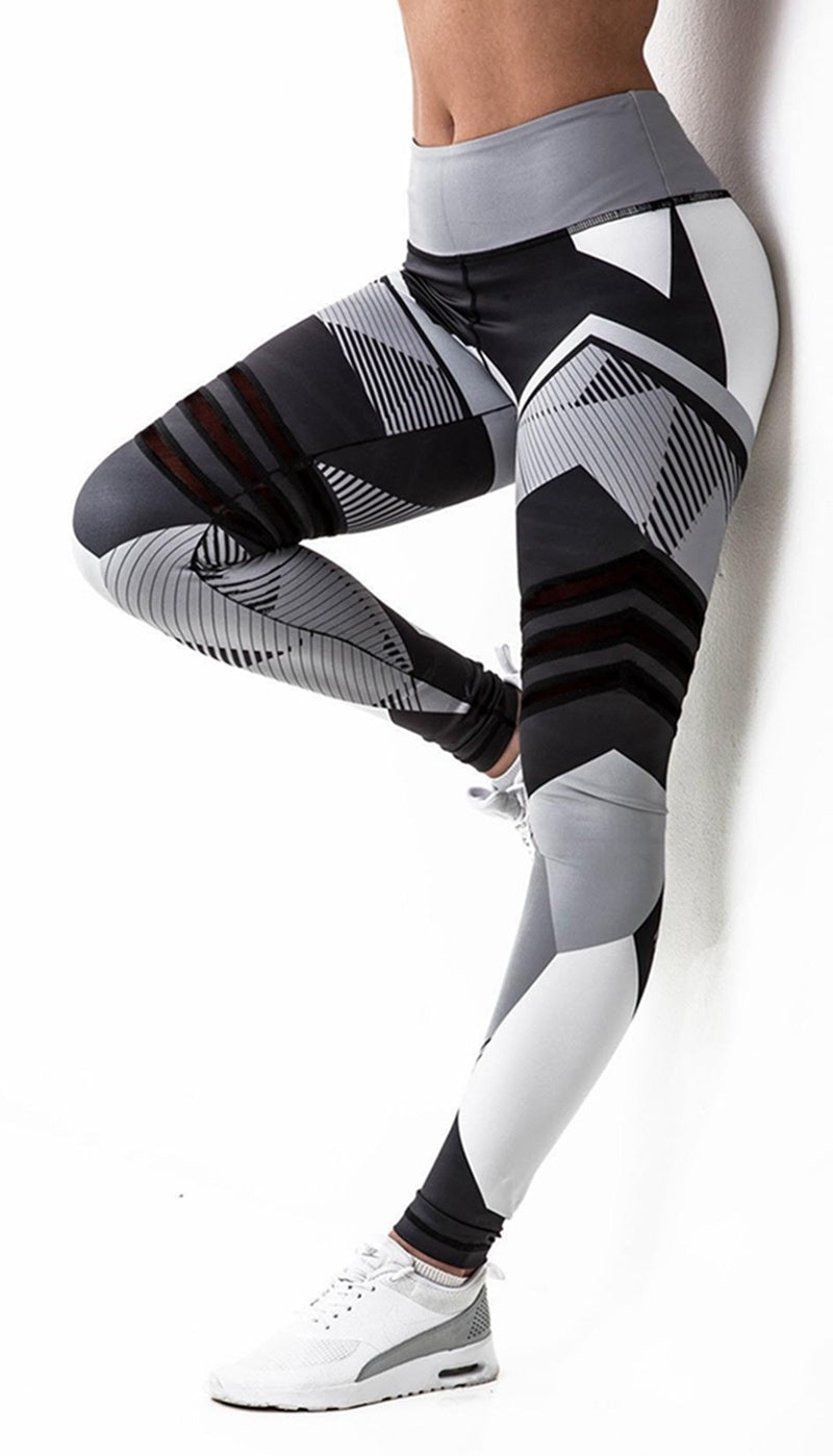 Black and gray patterned leggings worn by a person on a white background