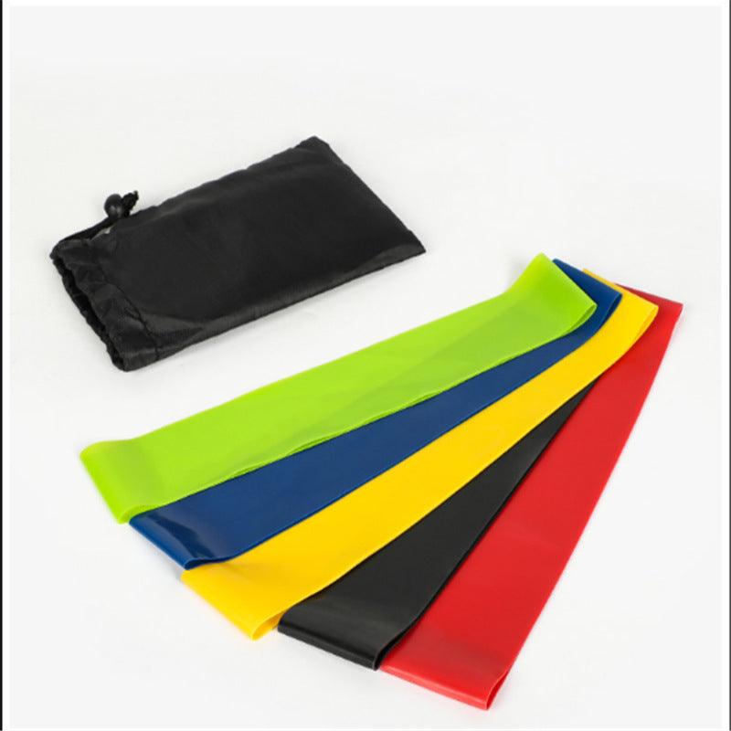 Set of colorful resistance bands with a black drawstring bag on a white background