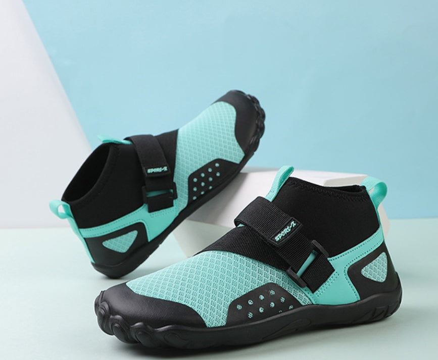 Pair of teal and black water shoes on a light blue background