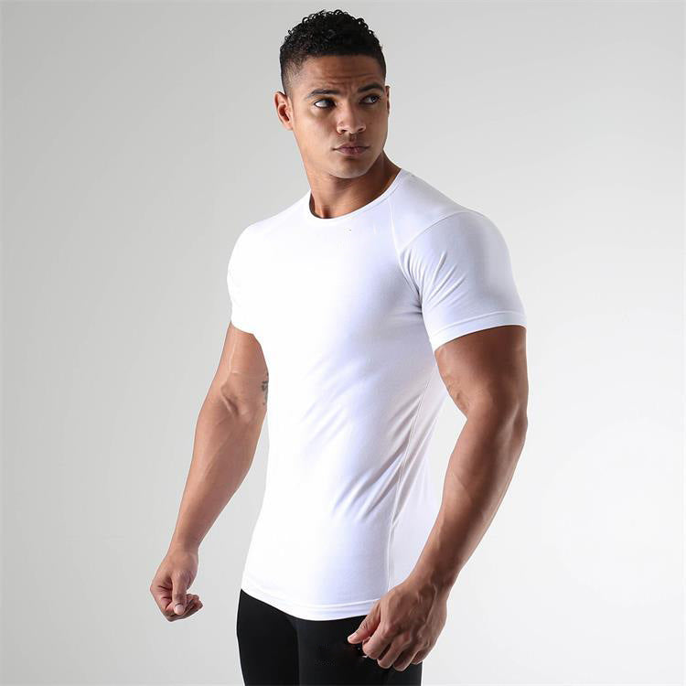 Man wearing a white t-shirt against a gray background