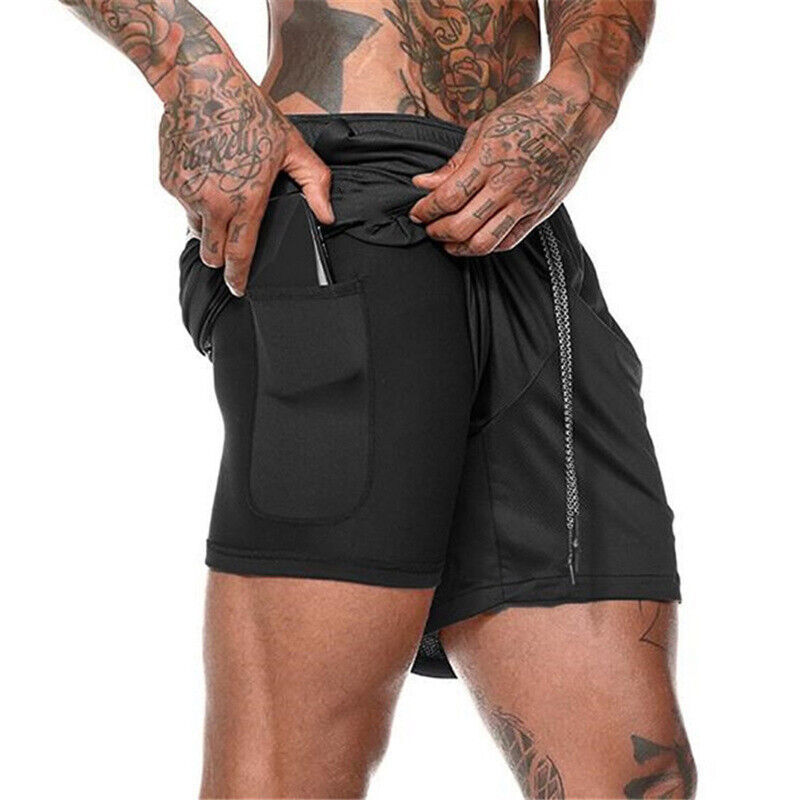 Person wearing black shorts with multiple pockets on a white background