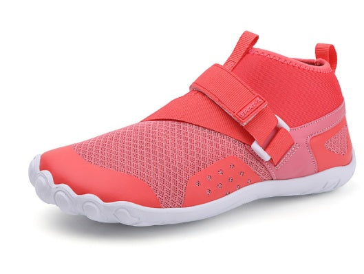Pink children's shoe with a strap on a white background