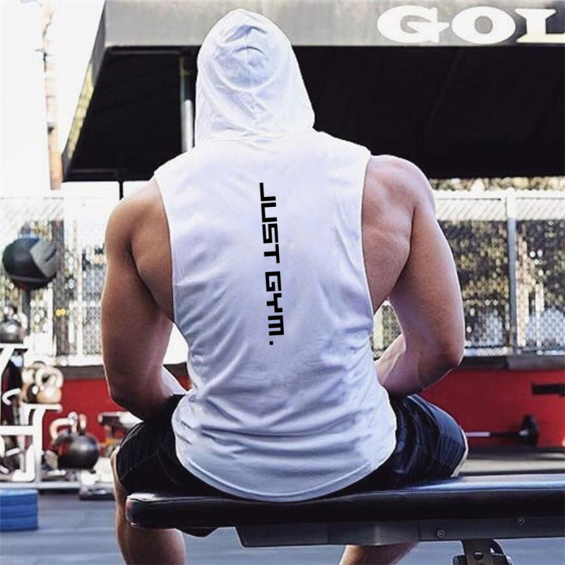 Person wearing a 'Just Gym' tank top sitting on a bench at a gym.