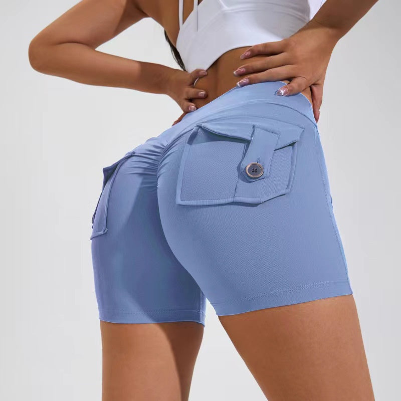 Person wearing light blue shorts with a pocket on a plain background