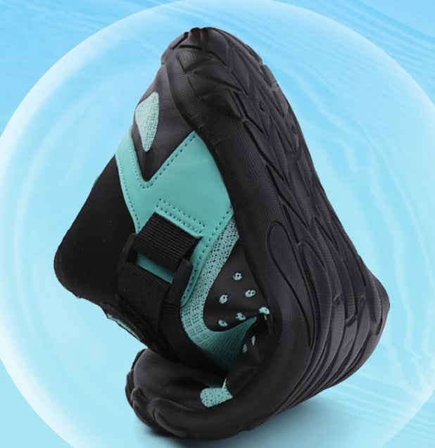 Black and teal sneaker on a light blue background