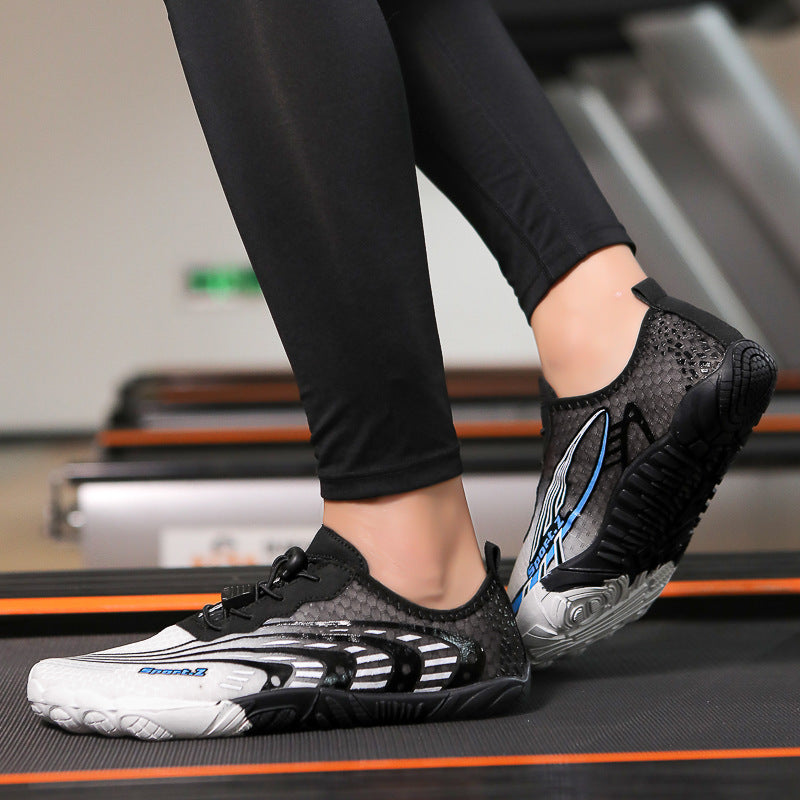 Person wearing black and white athletic shoes on a treadmill.