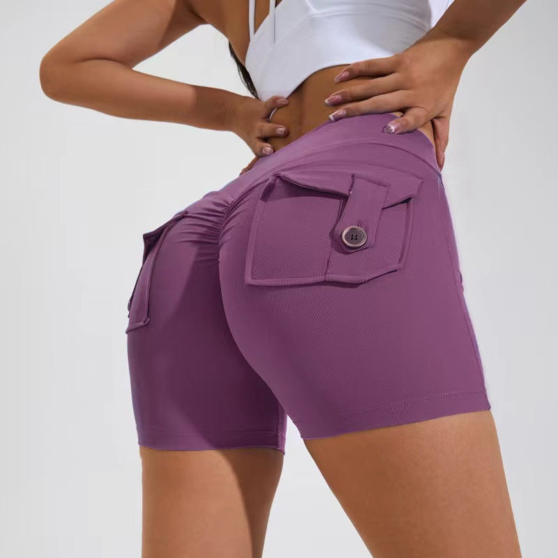 Purple athletic shorts with a pocket on a plain background