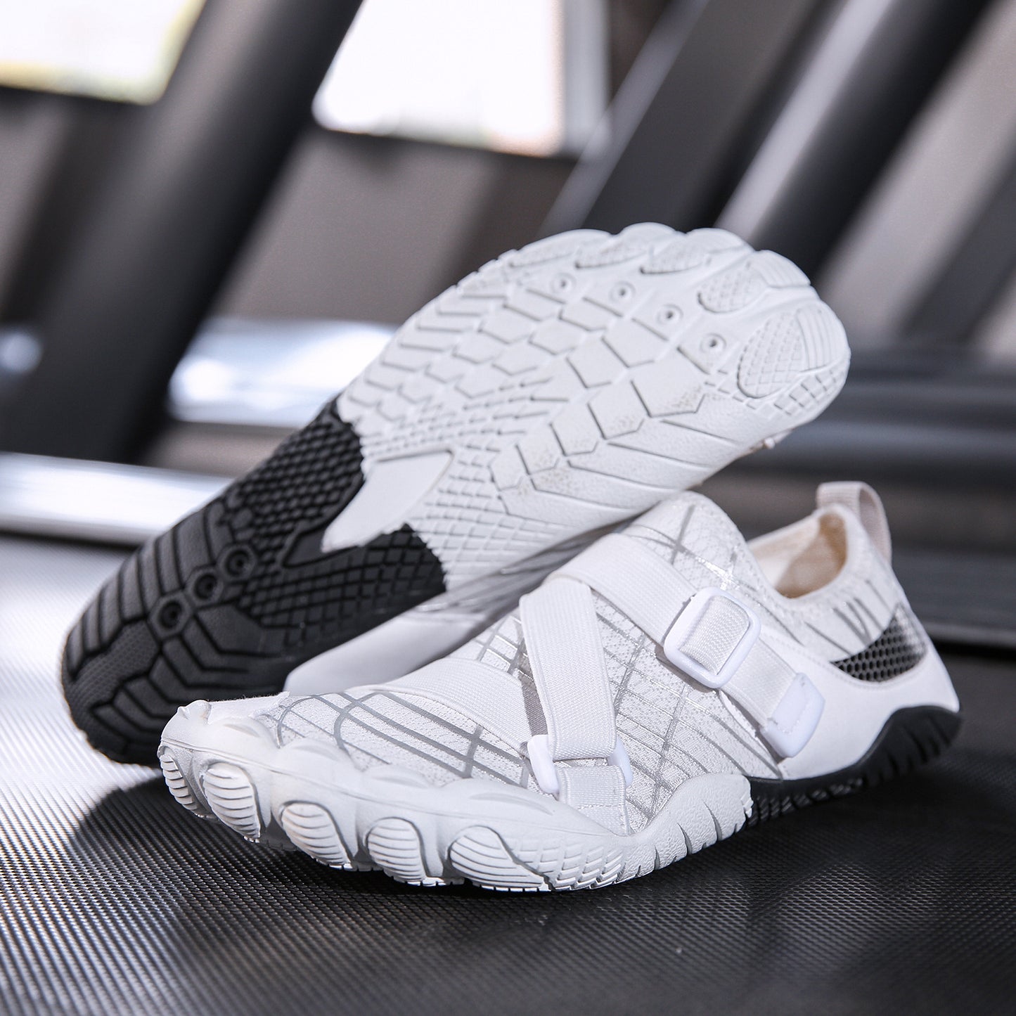 White and black slip-on shoes on a reflective surface with blurred background