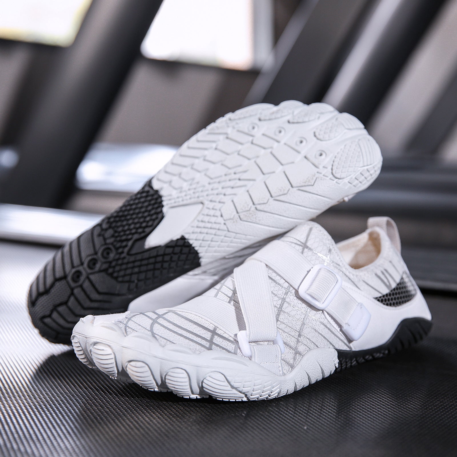 White and black slip-on shoes on a reflective surface with blurred background