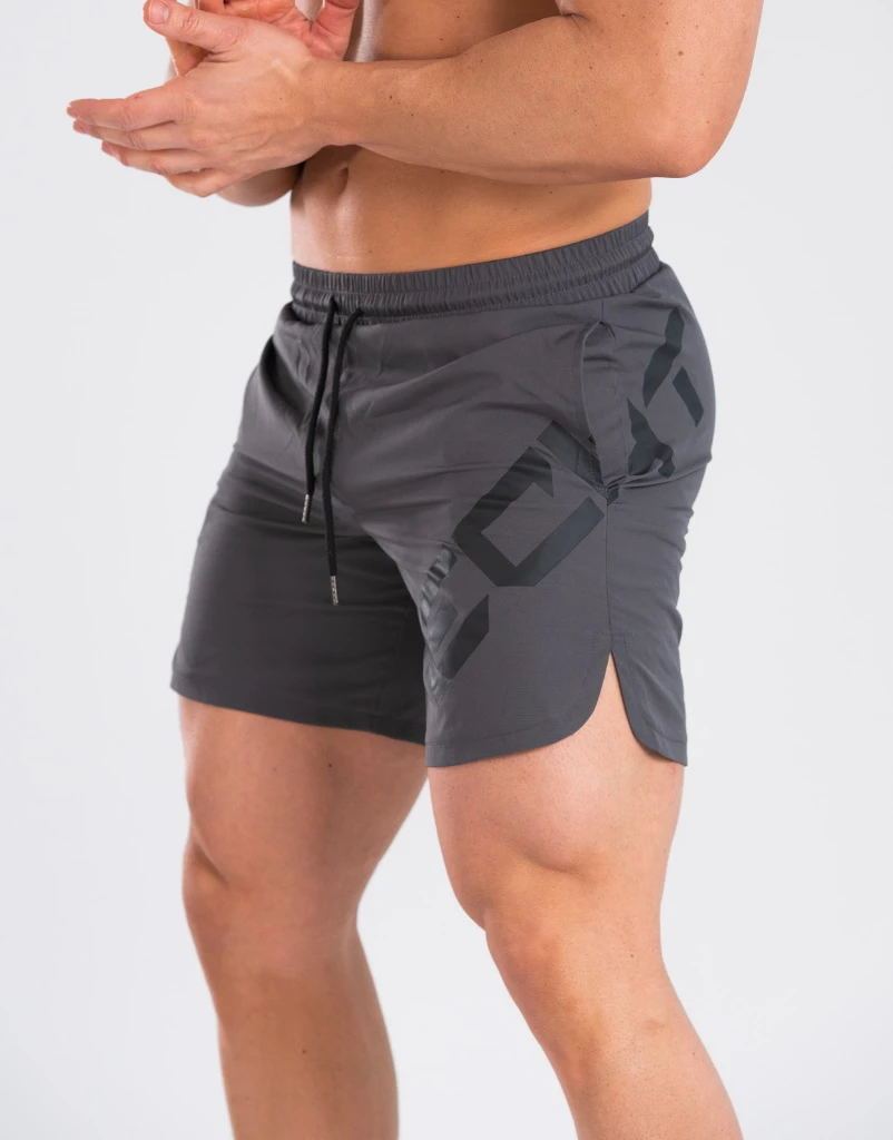 Person wearing gray athletic shorts with a geometric pattern on a white background