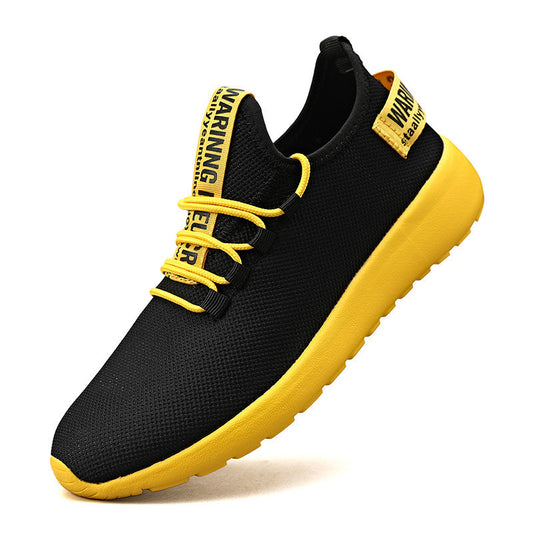Black and yellow sneaker with a prominent sole on a white background