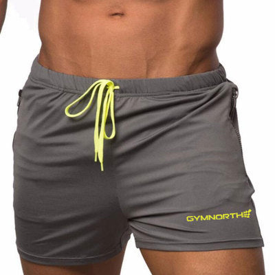 Gray shorts with a yellow drawstring and 'GYM NORTH' branding on a white background