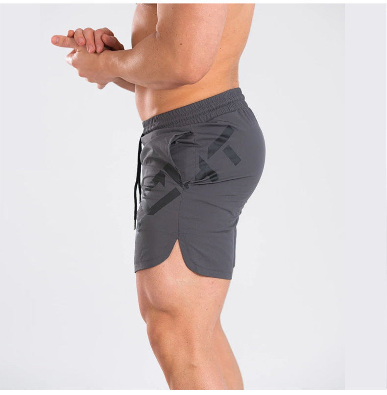 Person wearing gray athletic shorts on a white background
