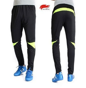 Black and yellow pants with a brand logo on a white background