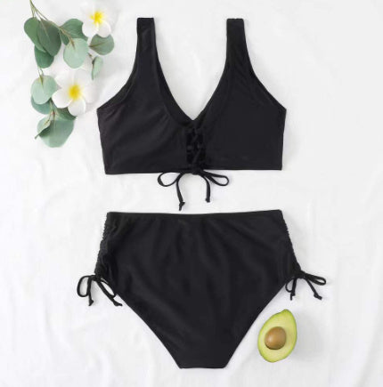 Black bikini set with avocado and flowers on a white background