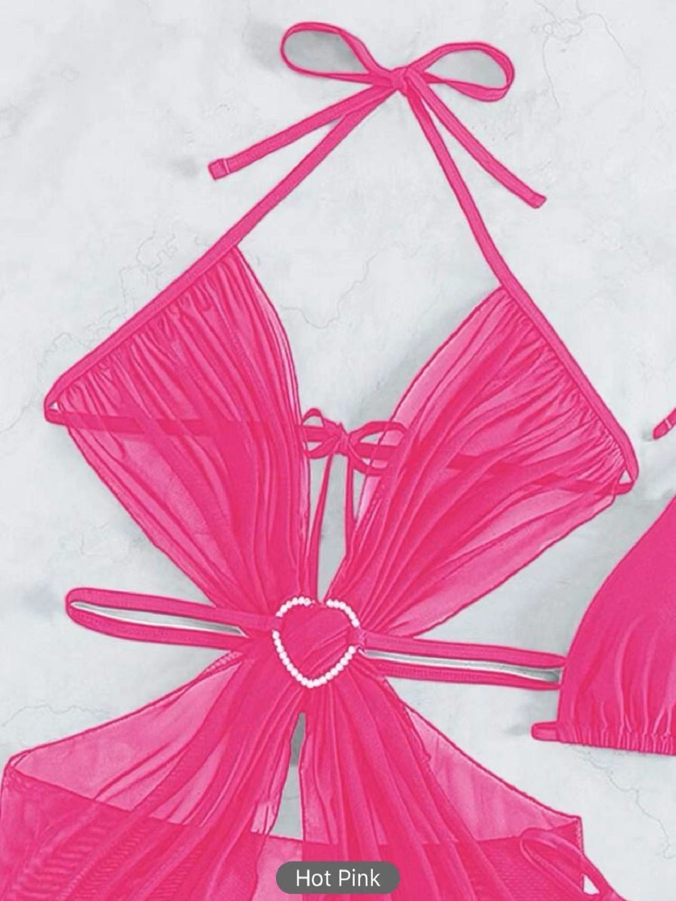 Hot pink bikini top with a bow detail on a white background