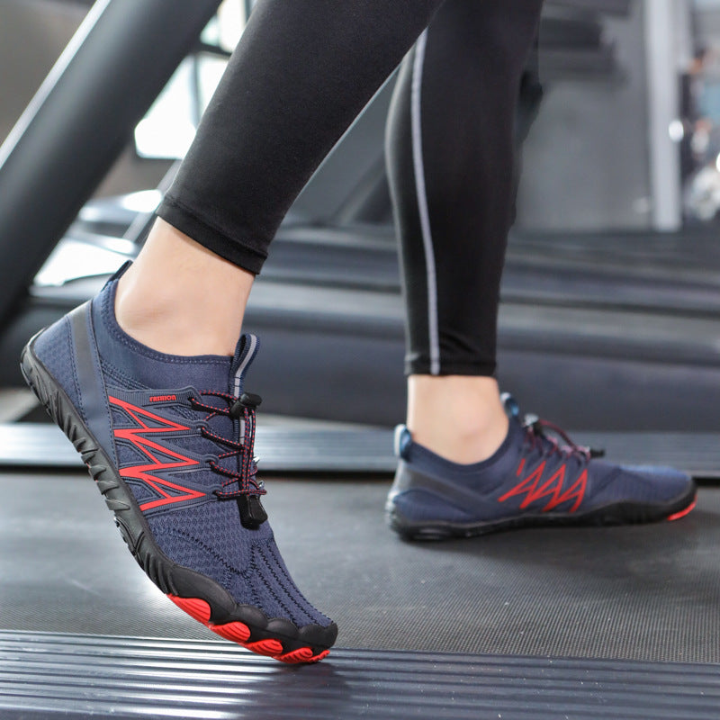 Person wearing blue athletic shoes with red accents on a treadmill.