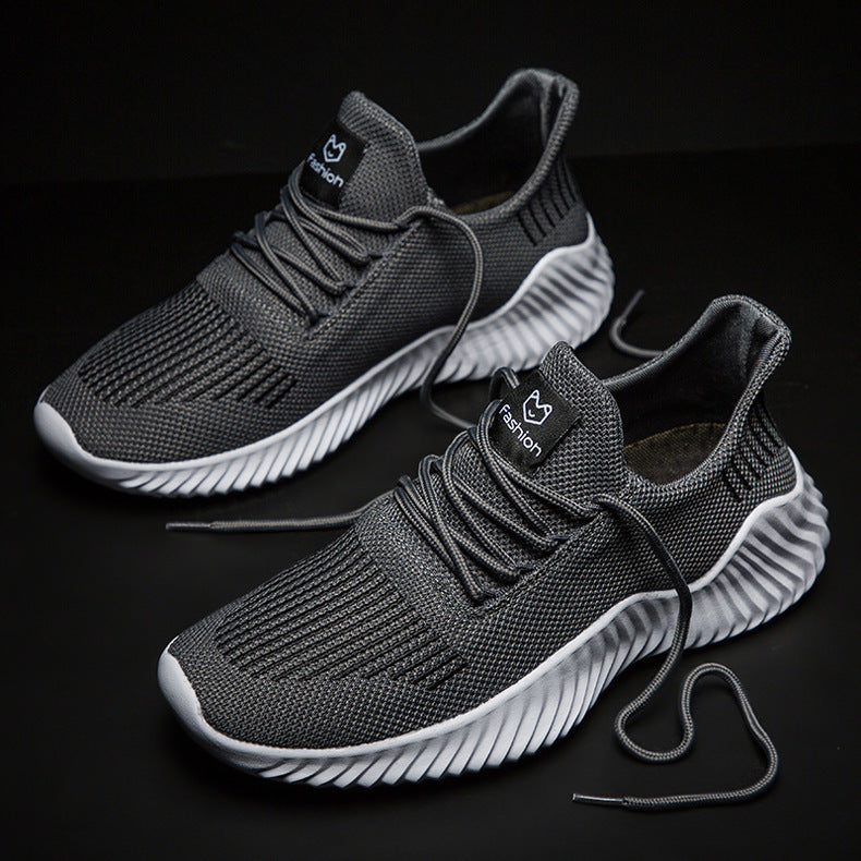 Gray sneakers with white soles on a black background