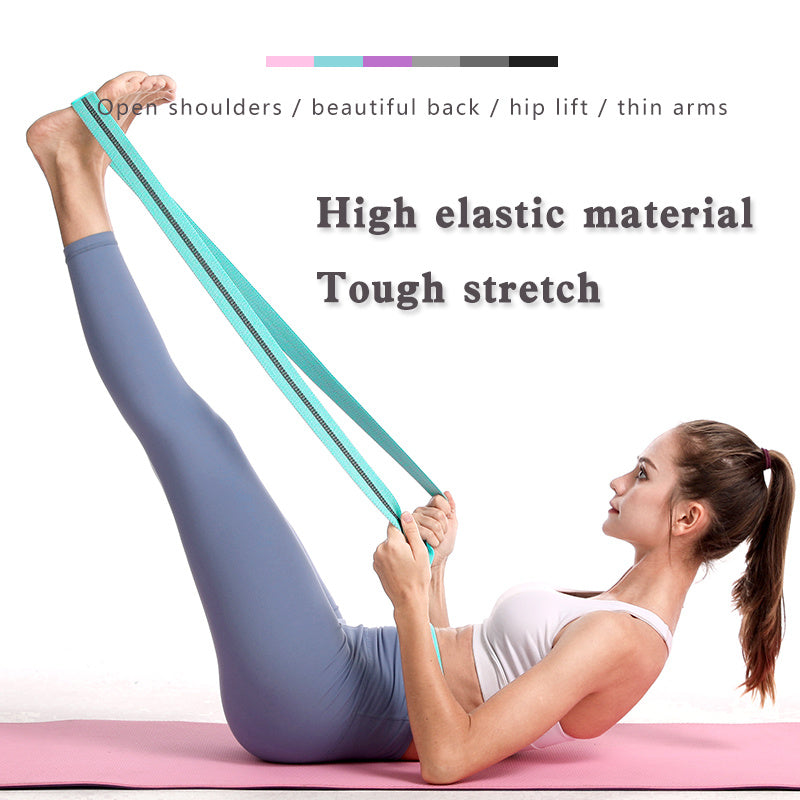 Woman using a resistance band for stretching exercises on a pink mat.