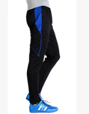 Black pants with blue accents worn by a person on a white background
