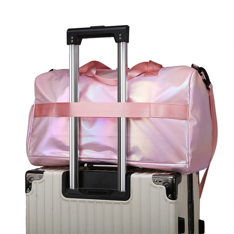 Pink duffel bag with a handle over a white suitcase on a white background