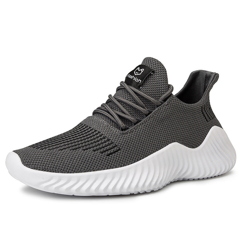 Gray athletic shoe with white sole on a white background