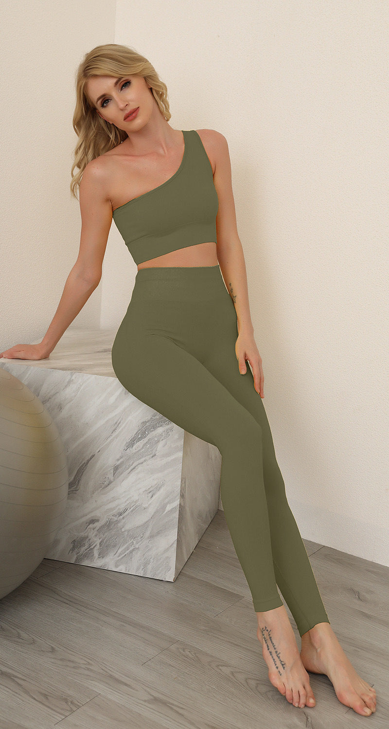 Woman wearing a green athletic outfit sitting on a marble block.