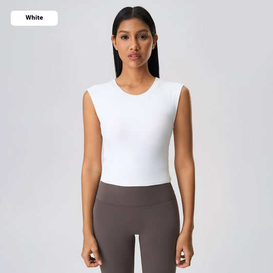 Woman wearing a white sleeveless top and gray leggings on a light gray background