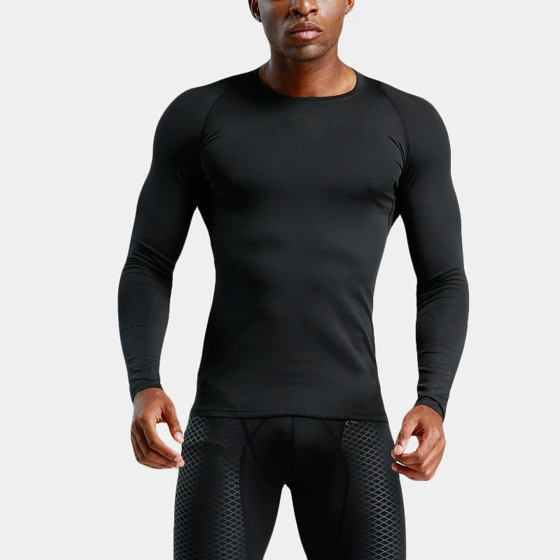 Person wearing a black long-sleeve athletic shirt and pants on a light gray background