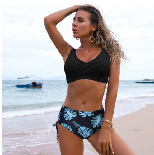 Woman in a black bikini with leaf pattern on a beach