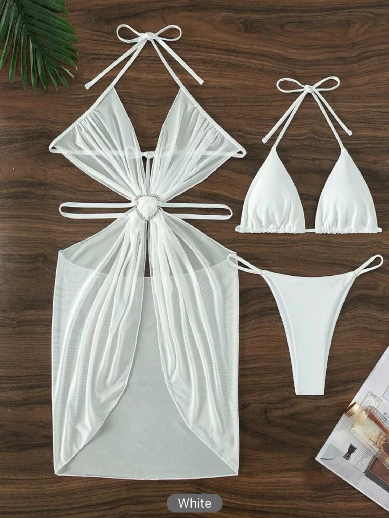 White bikini set with a bow design on a wooden surface